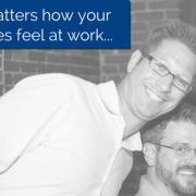 Two Employees smiling and looking at the camera with title - Why it matters how your employees feel at work