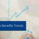 Hand drawing a graph going up with arrow on whiteboard with title - employee benefits trends