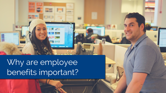 Two employees sitting at their desk, smiling and looking at the camera with title - why are employee benefits important
